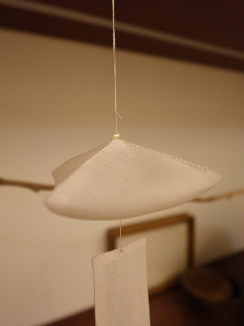 Close-up of the Oksa Silk Mobile's gathered silk dome and freshwater pearl crown